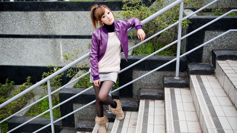 Woman in purple jacket on stairs