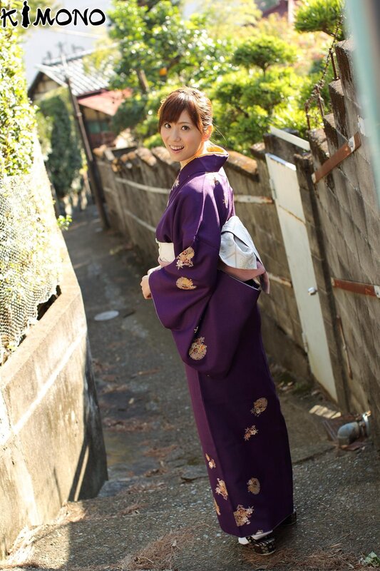 Woman in purple kimono on alleyway