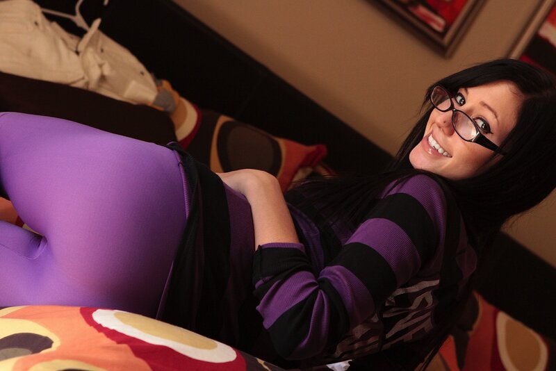 woman in purple leggings smiling