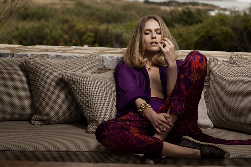 woman in purple outfit on couch