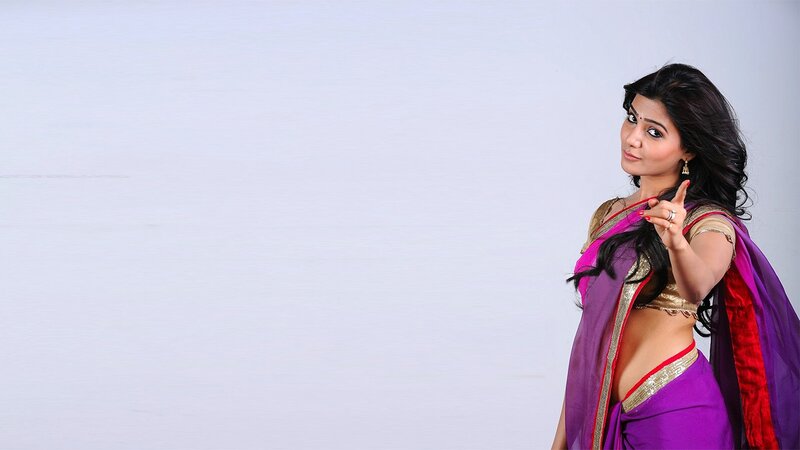 woman in purple saree pointing