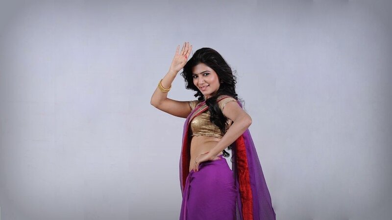 woman in purple sari waving