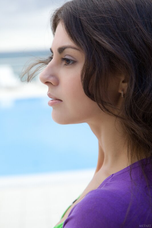 woman in purple shirt by pool