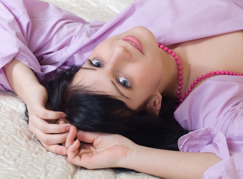 woman in purple shirt lying down