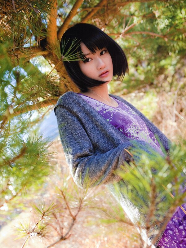 woman in purple shirt under pine tree