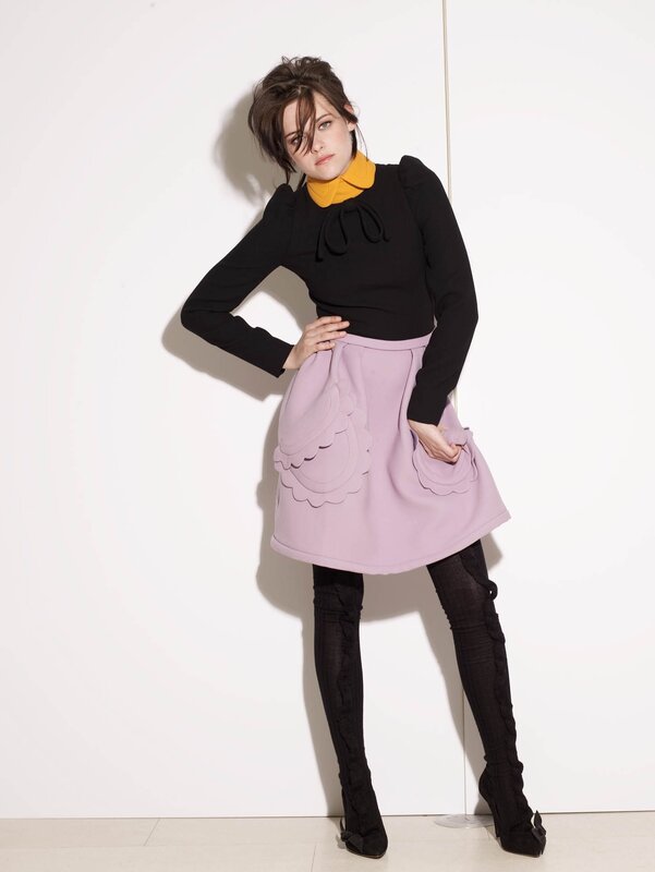 woman in purple skirt and black top