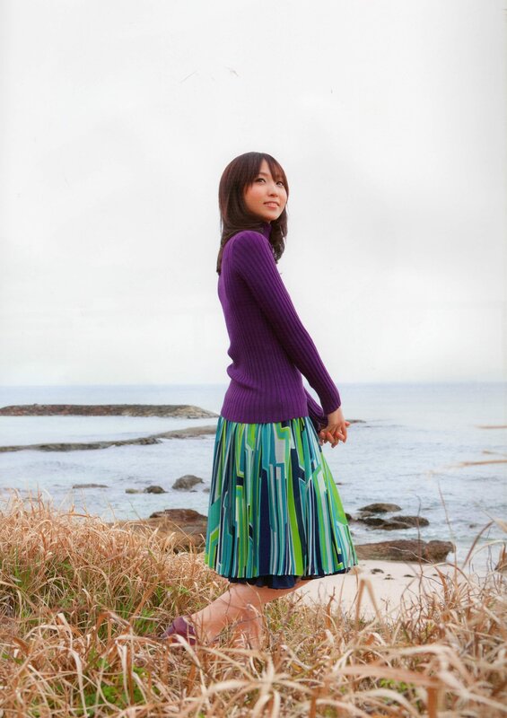 Woman in purple sweater at beach
