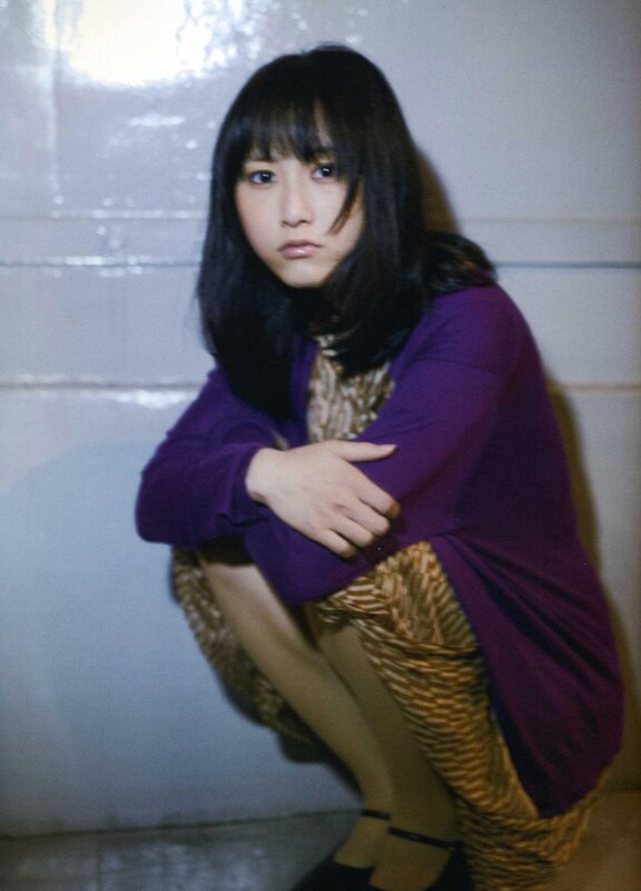woman in purple sweater crouching