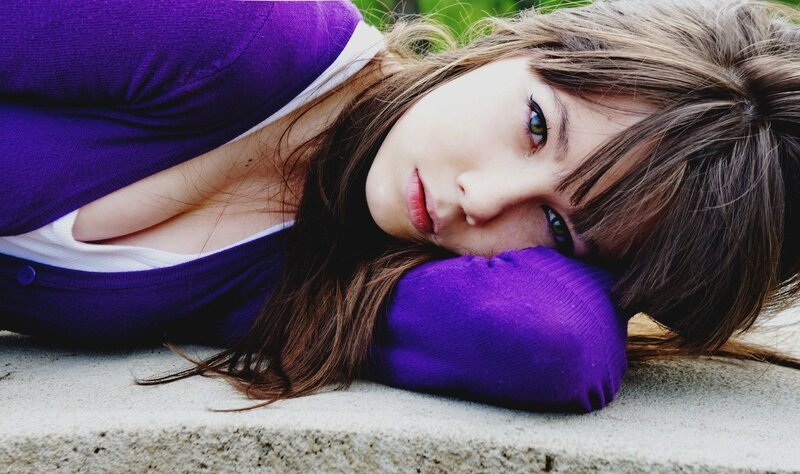 woman in purple sweater lying down