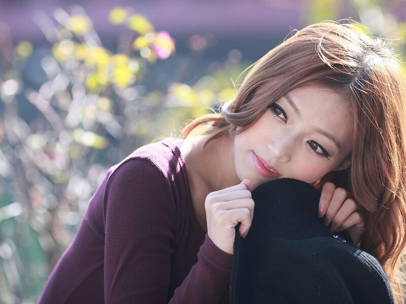 woman in purple sweater outdoors