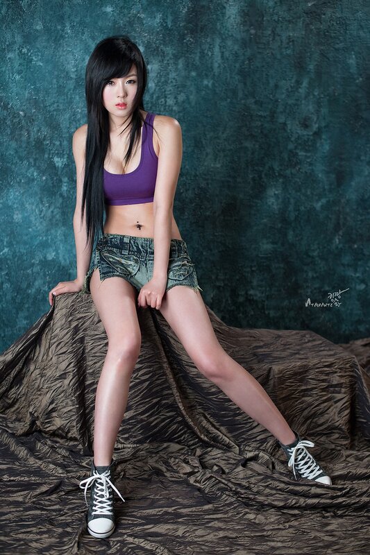 woman in purple top and denim shorts