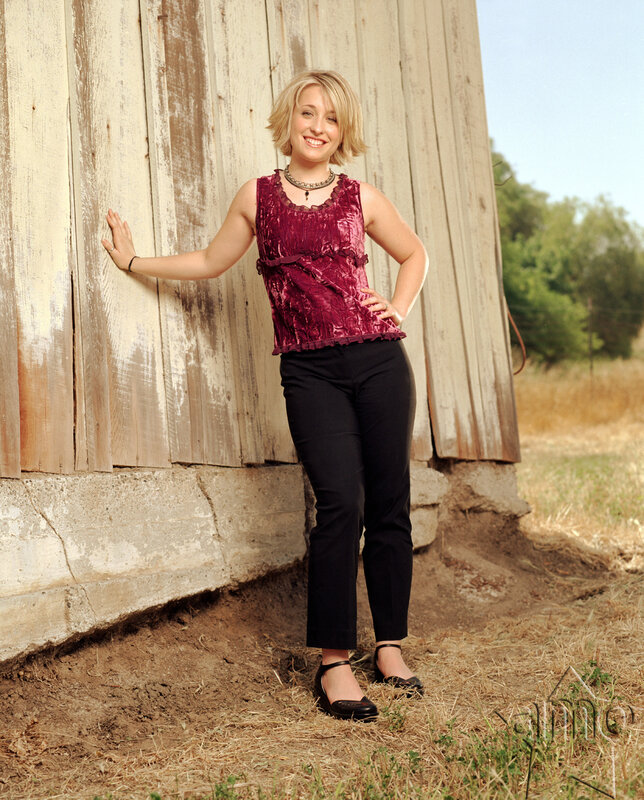 woman in purple top by barn