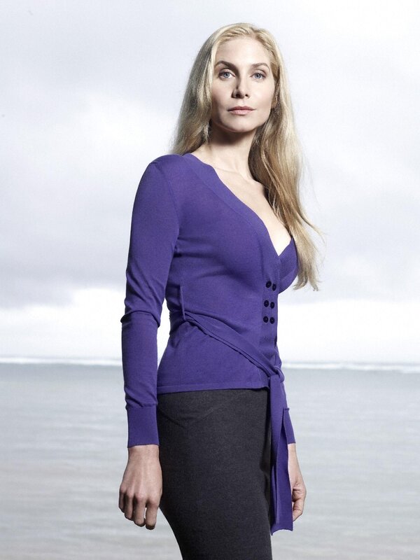woman in purple top by the sea