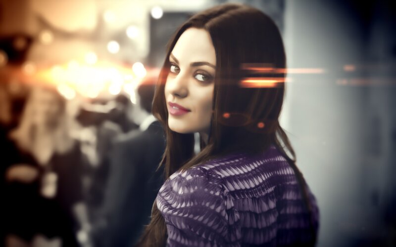 woman in purple top looking back