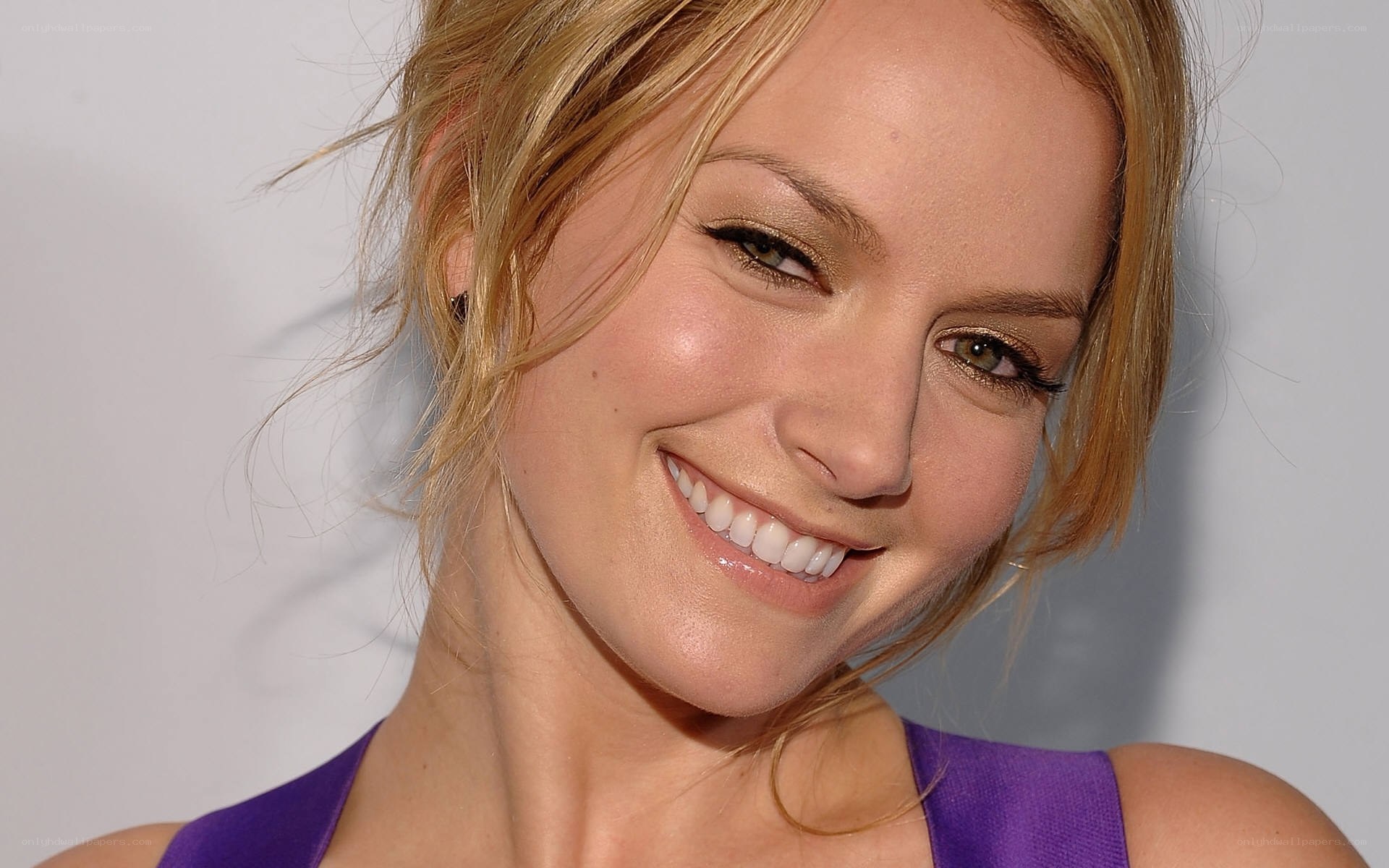 woman in purple top smiling