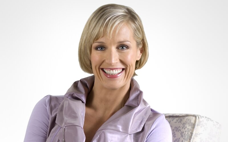 woman in purple top smiling