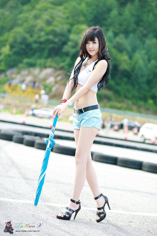 Woman in racing attire with umbrella