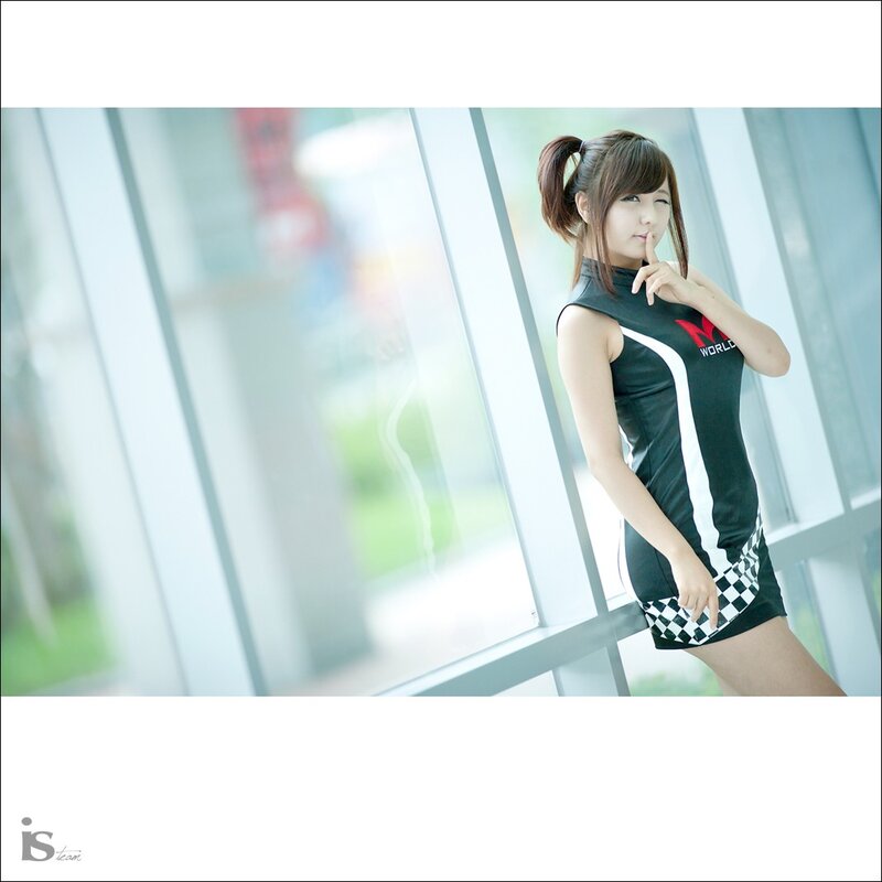 woman in racing dress by window