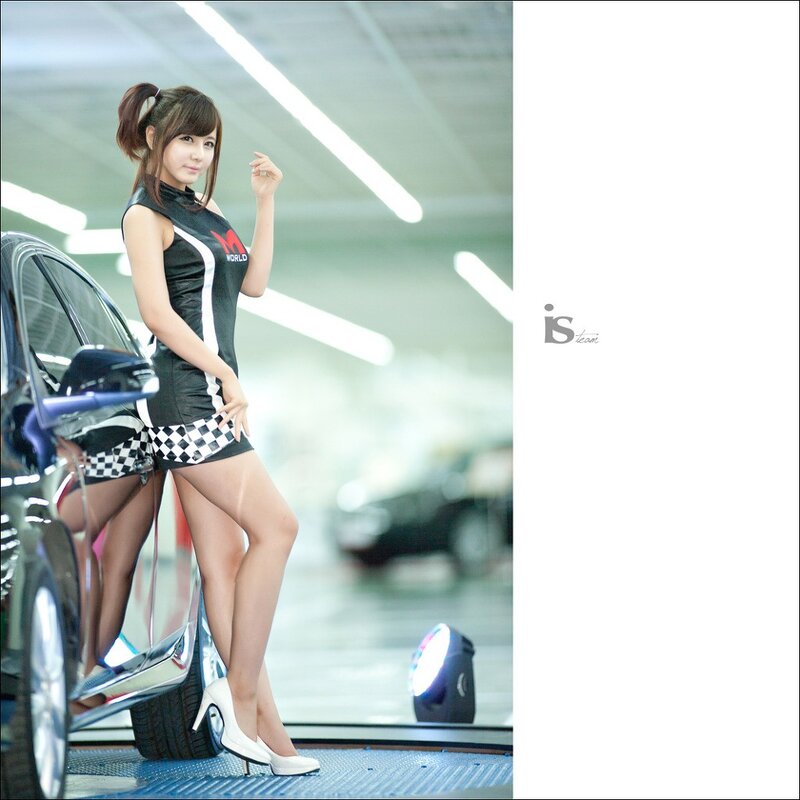 Woman in racing outfit at car show