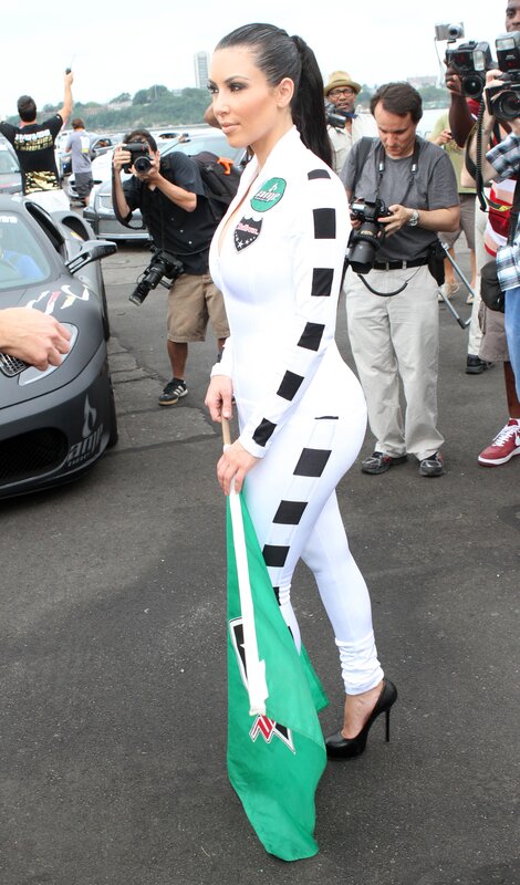 woman in racing suit with flag