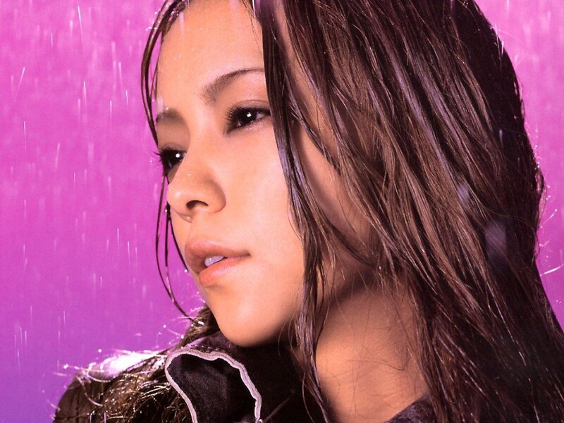 woman in rain against purple background