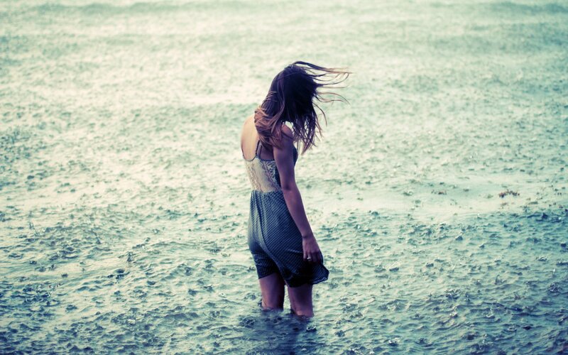 woman in rain at beach