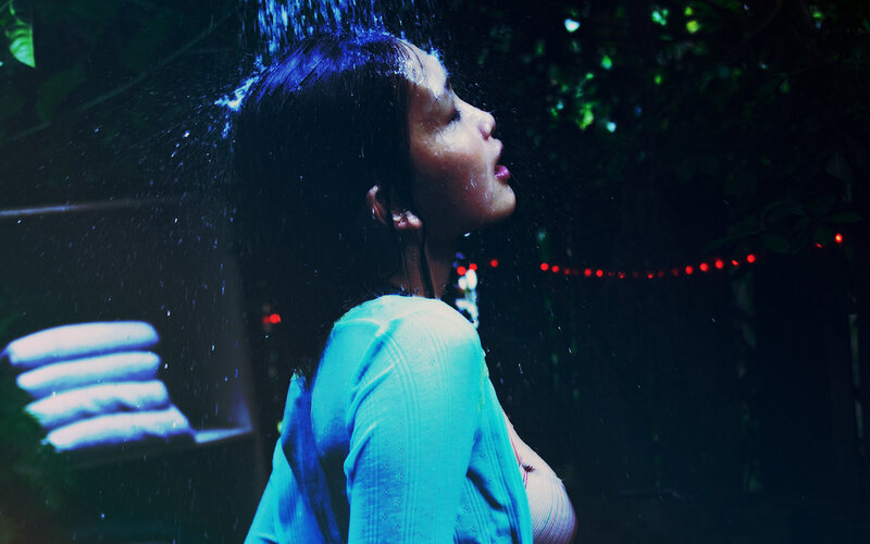 woman in rain at night