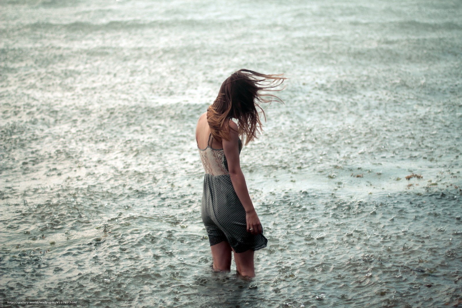Woman in rain at the shore