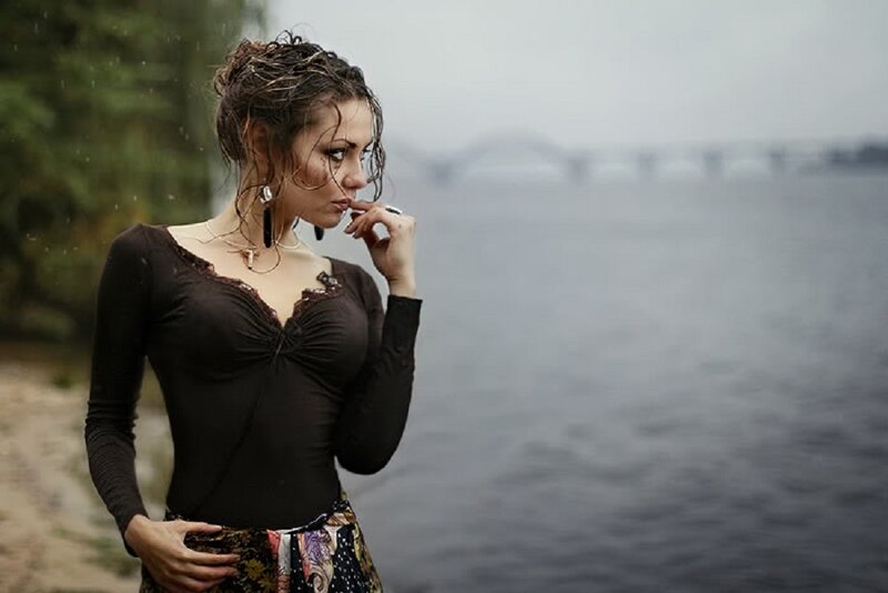 Woman in Rain by River — Brown