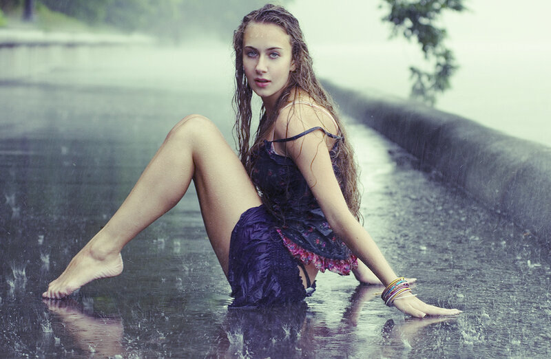 woman in rain by water