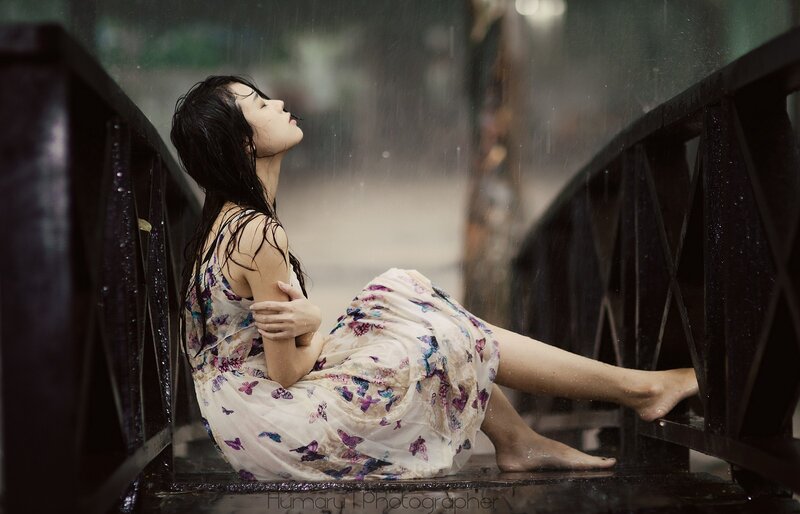 woman in rain on bridge