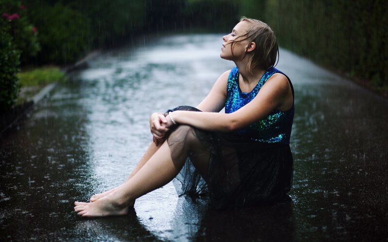 woman in rain on road
