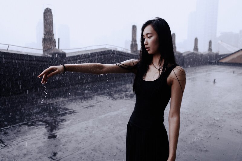 woman in rain on rooftop