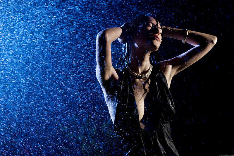 woman in rain under blue light