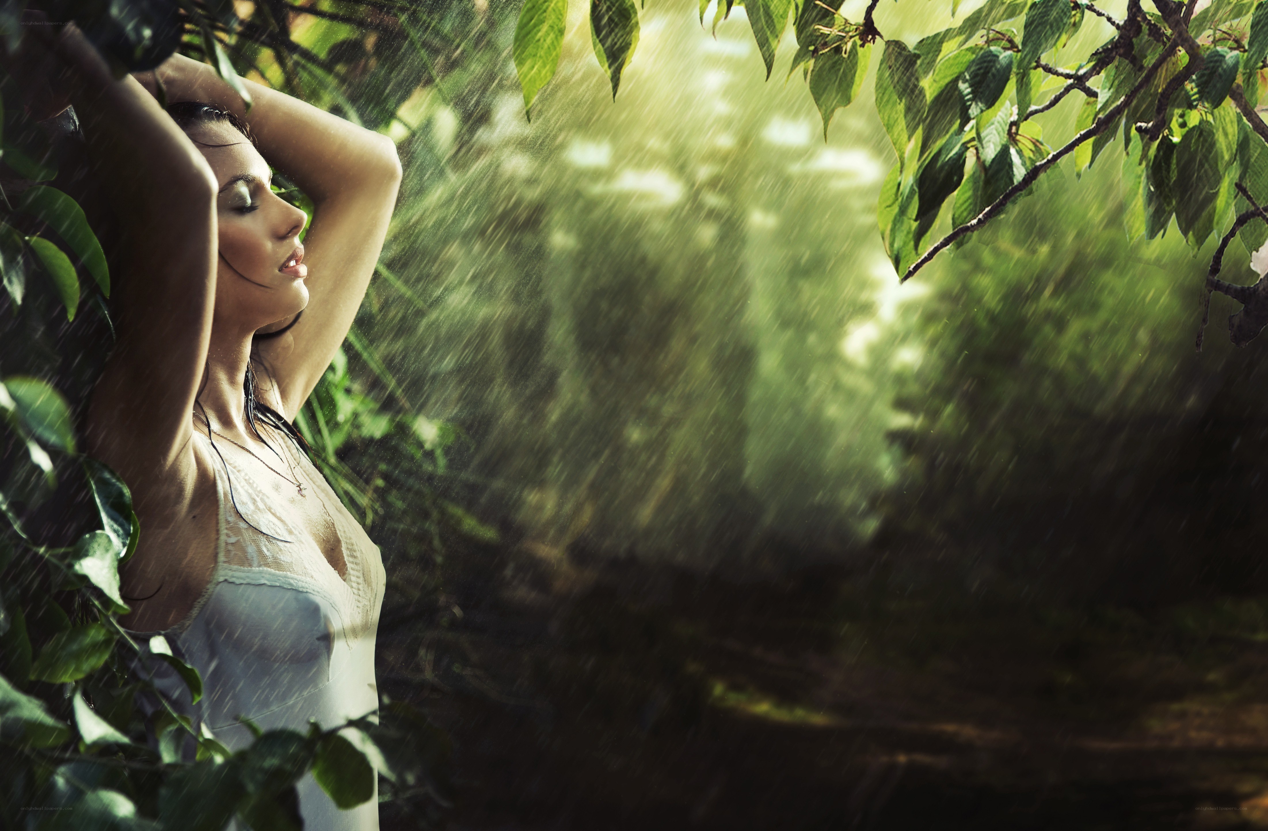 woman in rain under trees