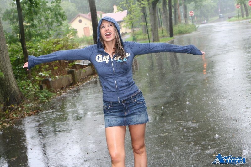 woman in rain with arms outstretched