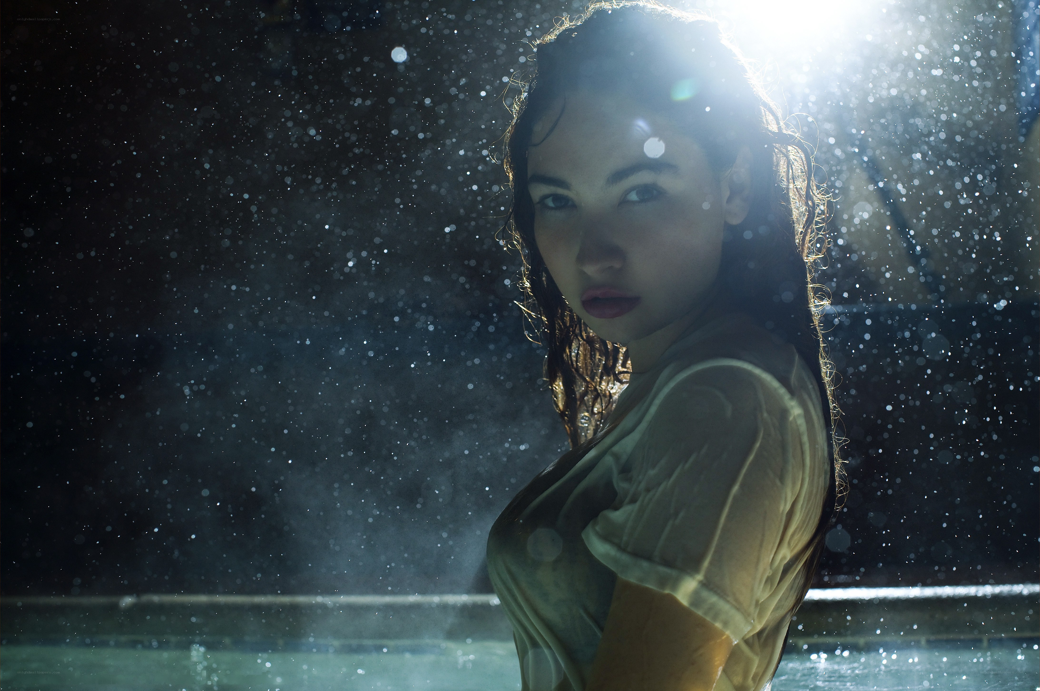 woman in rain with backlight