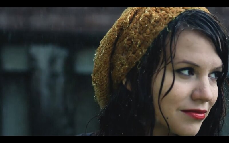 woman in rain with beret