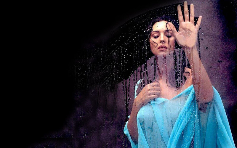 woman in rain with blue sari