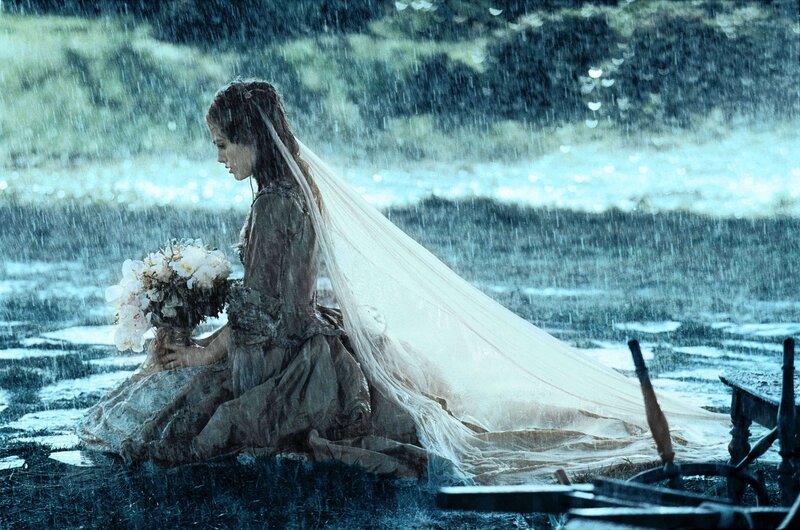 woman in rain with bouquet