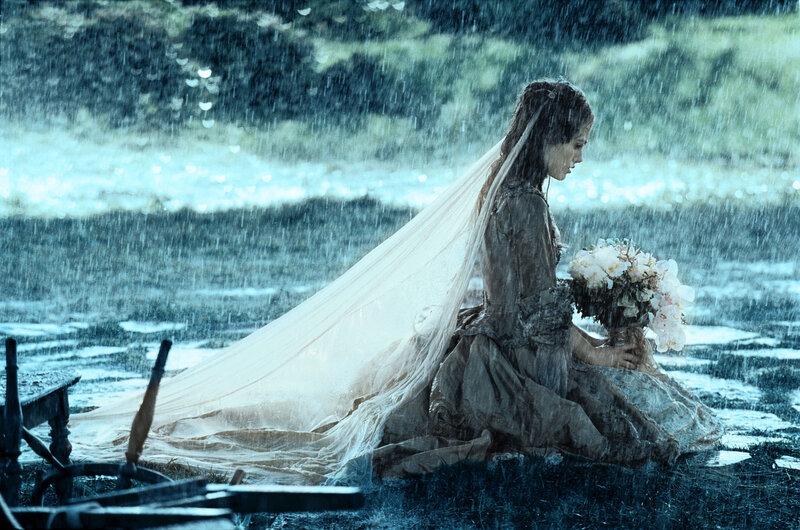woman in rain with bouquet