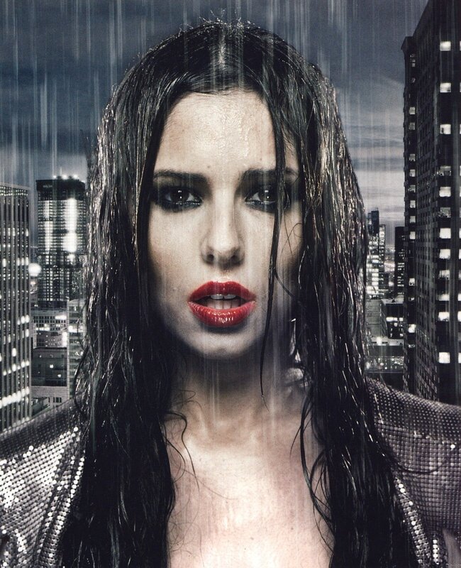 woman in rain with city background