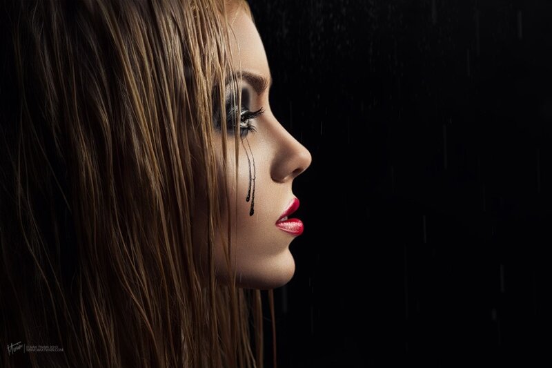 woman in rain with dark makeup