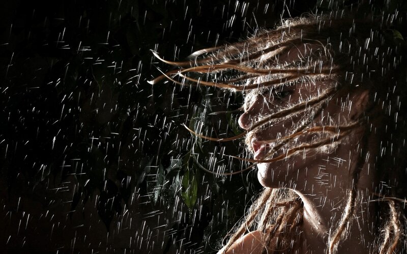 woman in rain with dreadlocks