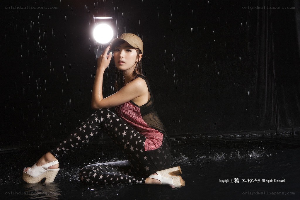 woman in rain with flashlight