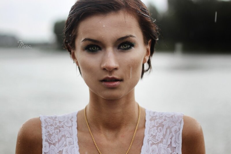 woman in rain with green eyes