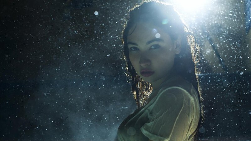 woman in rain with light