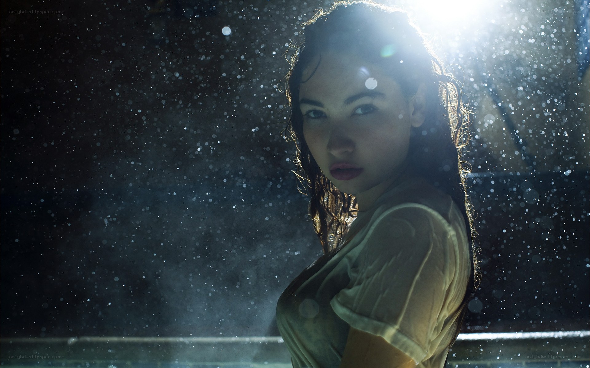 woman in rain with light