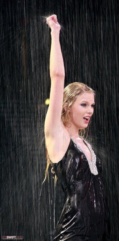 woman in rain with raised arm