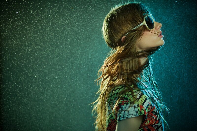 woman in rain with sunglasses